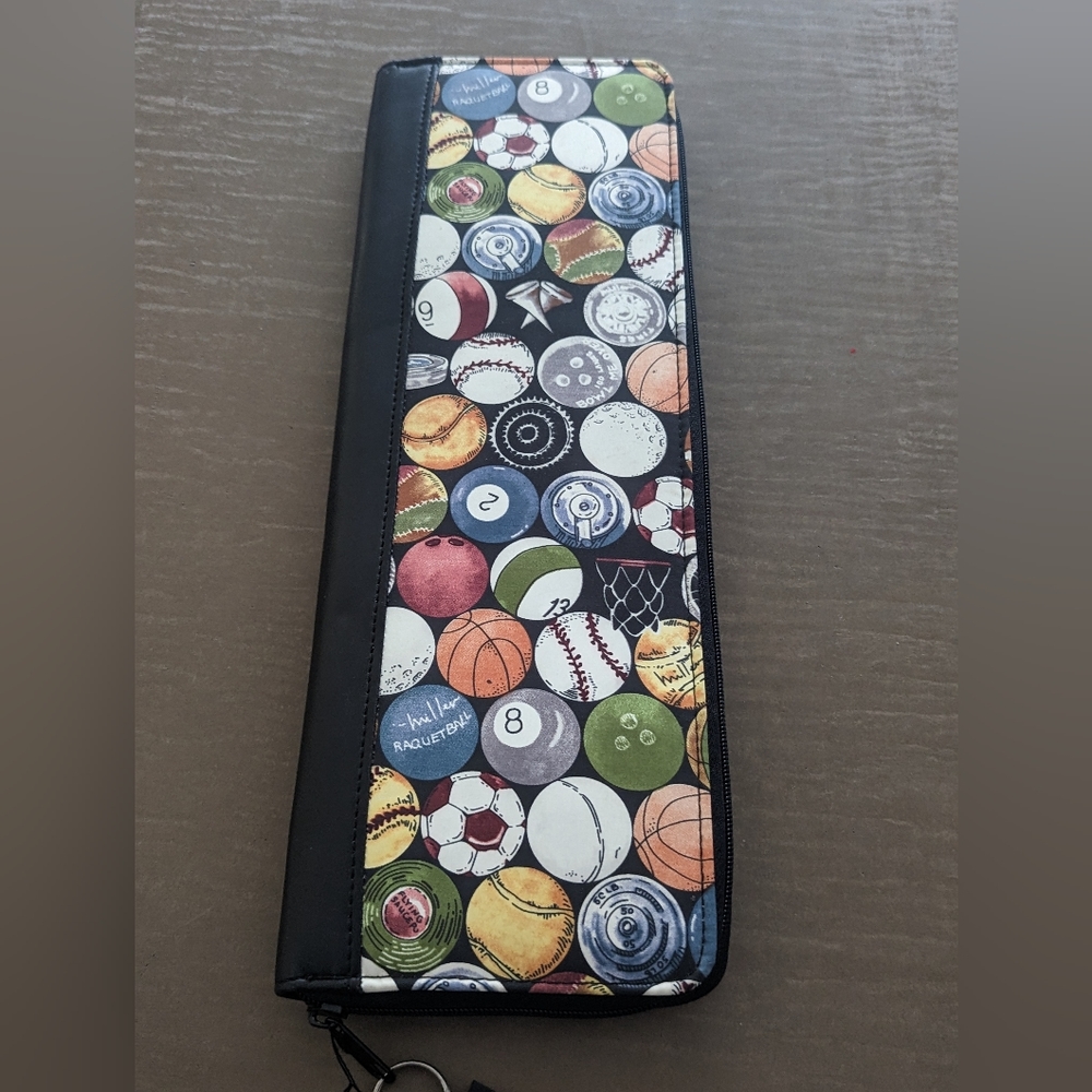 Nicole Miller travel tie case with sports balls design.